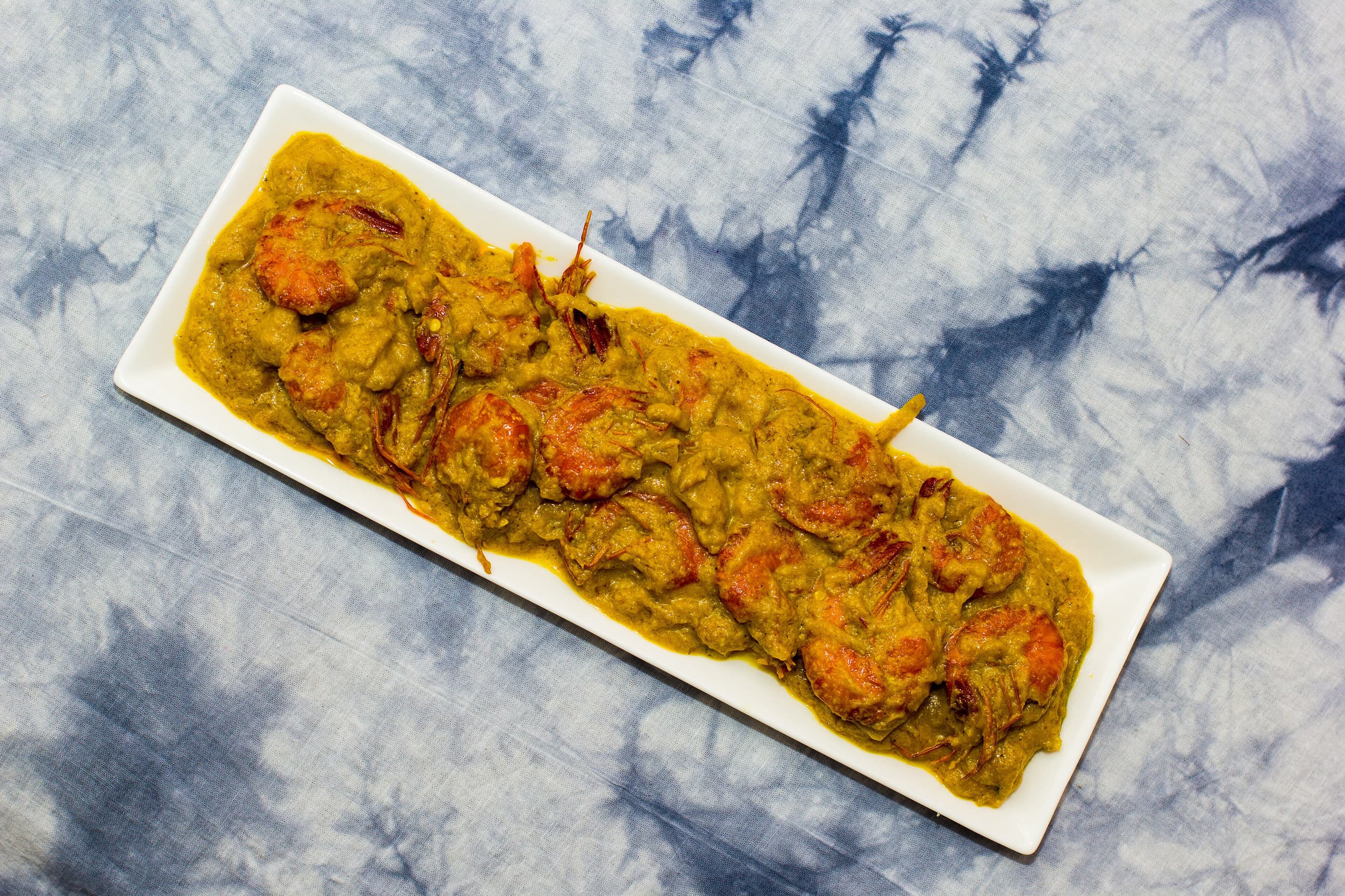 A plate of prawn curry, rich with spices.